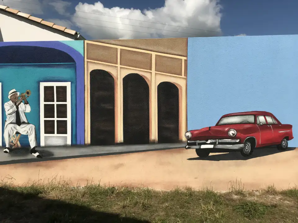 peinture style cuba avec un trompetiste et une vielle voiture rouge